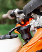 Close-up of a KTM motorcycle 2-stroke oil filler with a DIRT-EH 2-stroke oil funnel