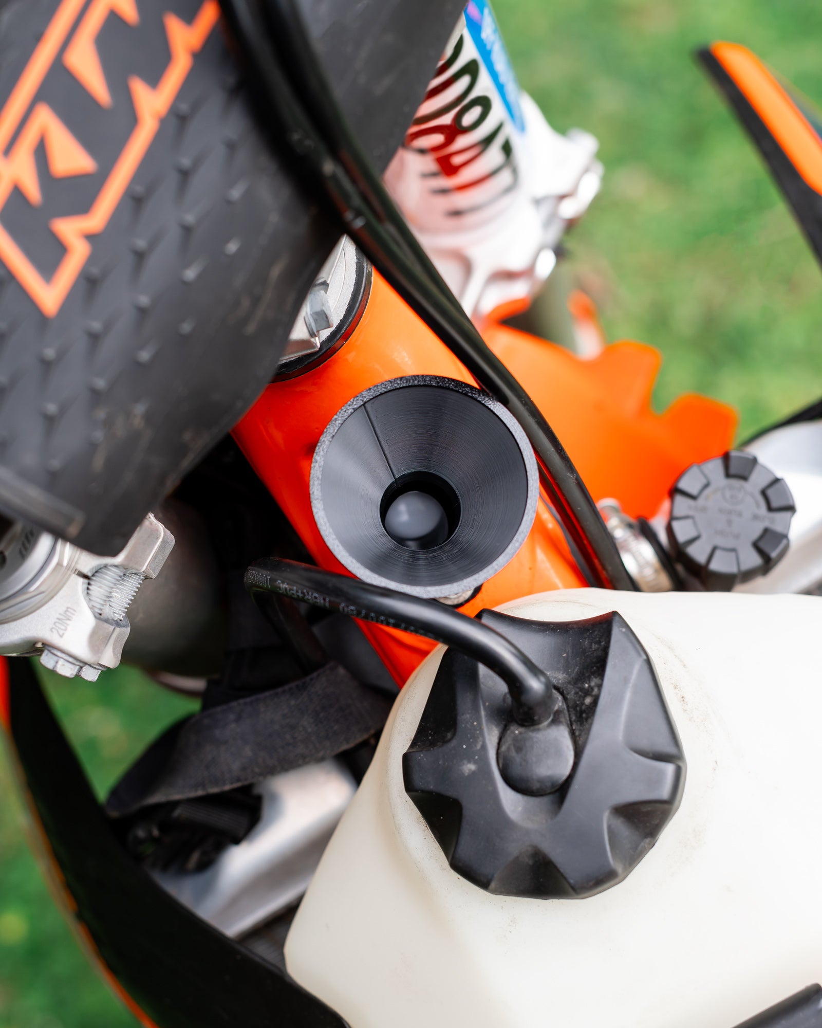 Close-up of a KTM motorcycle 2-stroke oil filler with a DIRT-EH 2-stroke oil funnel