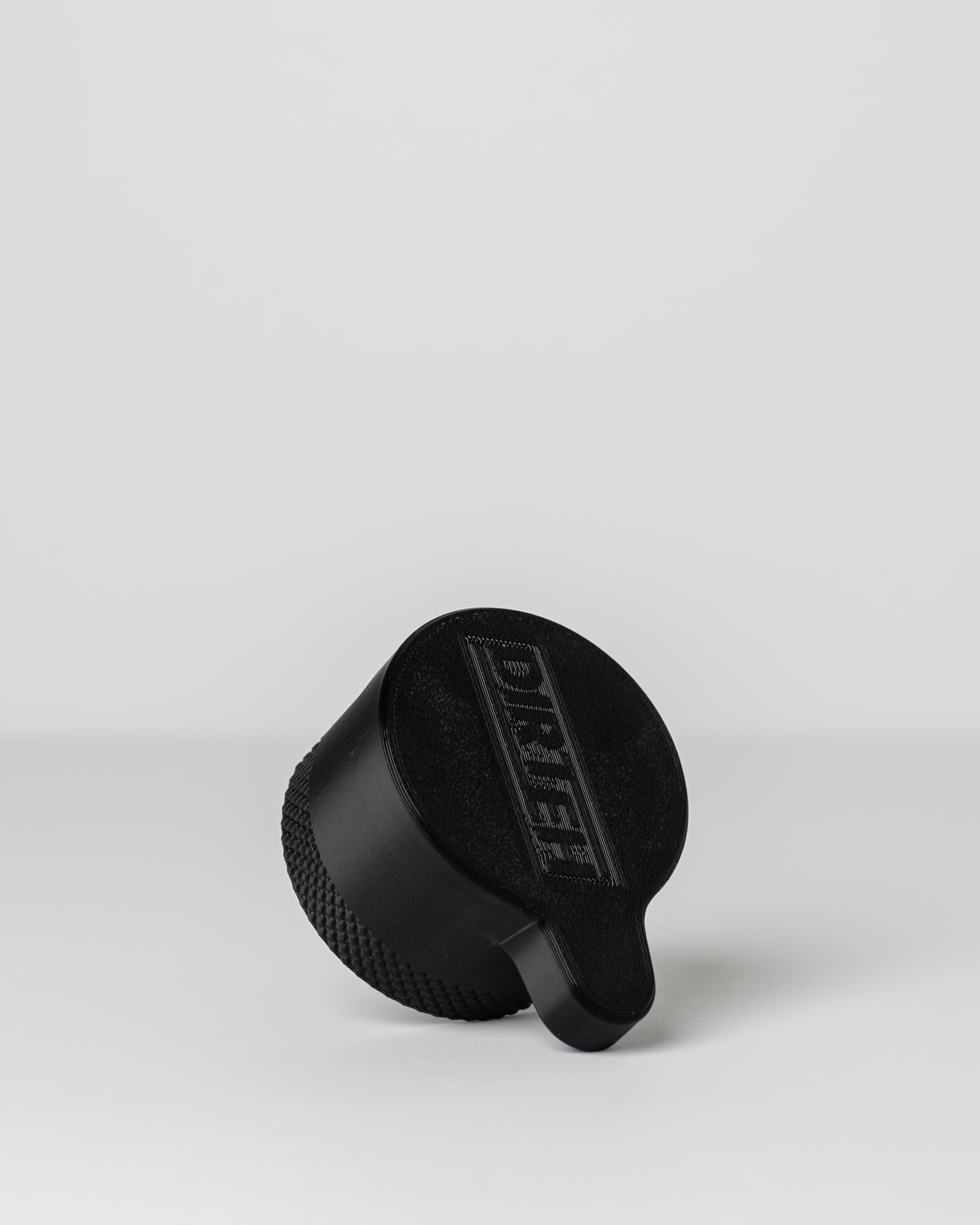 DIRT-EH radiator cap removal tool on a light gray background
