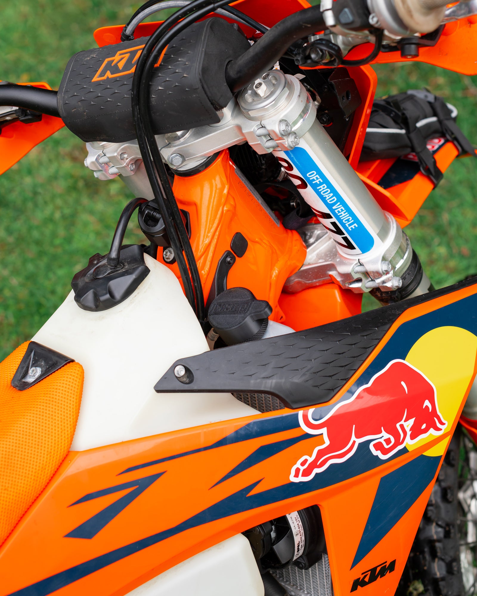 Close-up of a KTM motorcycle radiator with a DIRT-EH radiator cap removal tool