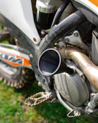 Close-up of a KTM motorcycle engine with a DIRT-EH threaded oil funnel