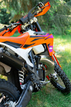 Close-up of a KTM motorcycle engine with a DIRT-EH threaded oil funnel
